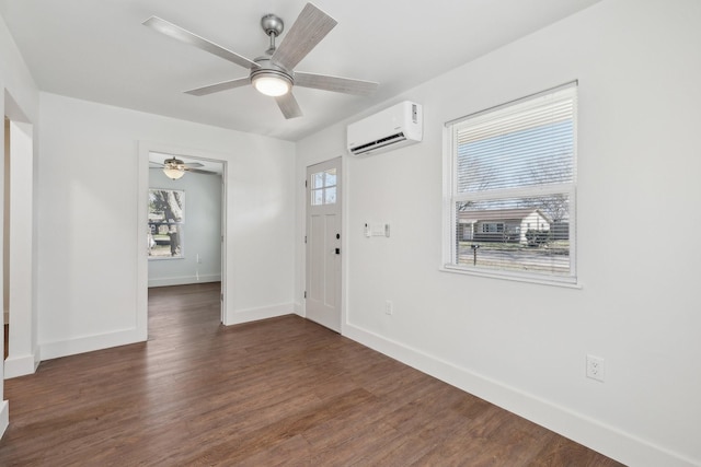 foyer with dark hardwood / wood-style flooring, a wall unit AC, and ceiling fan