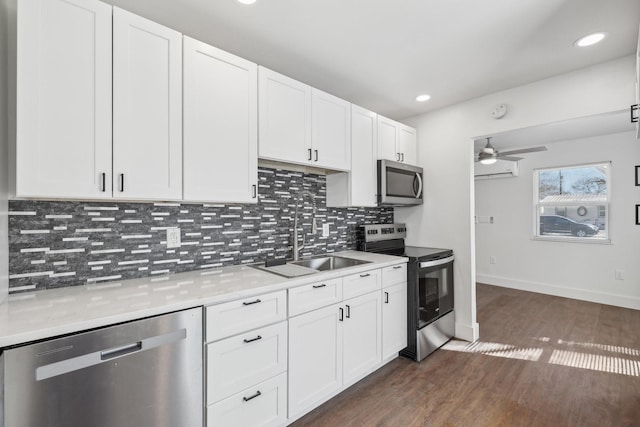 kitchen featuring white cabinetry, appliances with stainless steel finishes, sink, and dark hardwood / wood-style floors