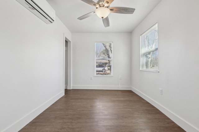 spare room with dark wood-type flooring, ceiling fan, and a wall unit AC