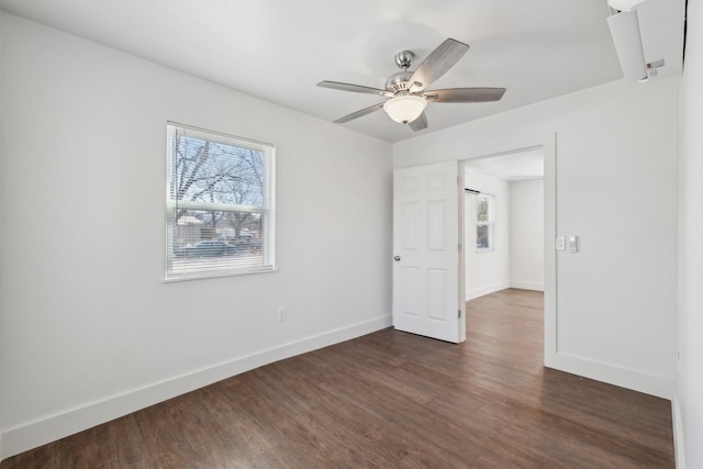 spare room featuring ceiling fan and dark hardwood / wood-style floors