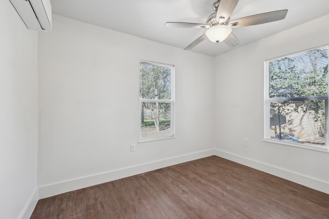 empty room featuring ceiling fan, dark hardwood / wood-style flooring, and a wall unit AC