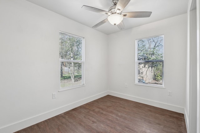 unfurnished room featuring ceiling fan, plenty of natural light, and dark hardwood / wood-style floors