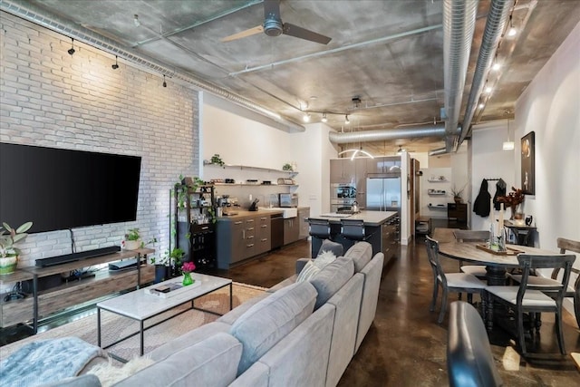 living room with ceiling fan and brick wall