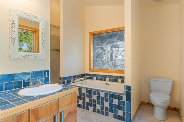 212 Comanche Cp, Kyle, TX 78640 - full bathroom with tile patterned flooring, toilet, a garden tub, and vanity