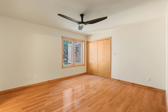 212 Comanche Cp, Kyle, TX 78640 - unfurnished bedroom with light wood finished floors, baseboards, a closet, and ceiling fan