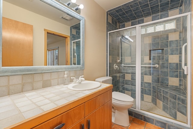 212 Comanche Cp, Kyle, TX 78640 - full bathroom with a stall shower, tile patterned flooring, tasteful backsplash, and toilet