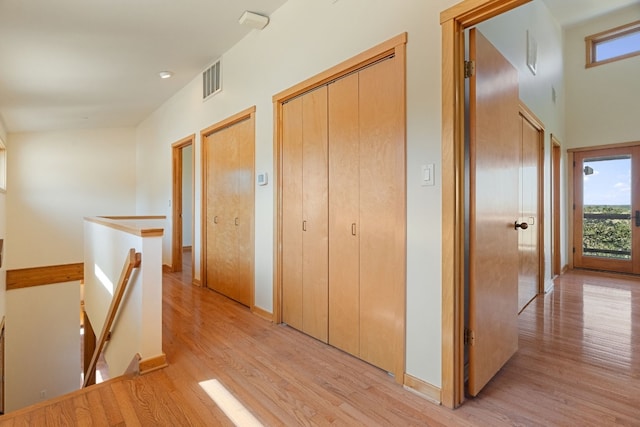 212 Comanche Cp, Kyle, TX 78640 - hall featuring an upstairs landing, light wood finished floors, and baseboards