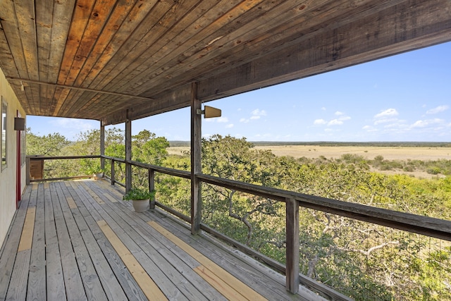 wooden deck with a rural view