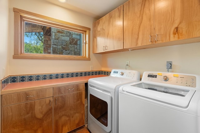 212 Comanche Cp, Kyle, TX 78640 - laundry room with cabinet space and washing machine and dryer