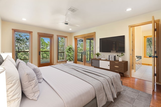 bedroom with ceiling fan, light wood-type flooring, multiple windows, and access to outside