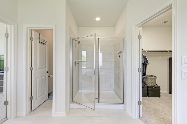 bathroom with walk in shower and tile patterned floors