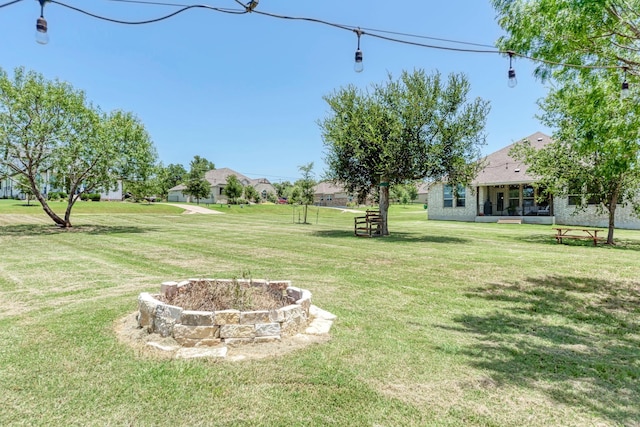 view of yard with an outdoor fire pit