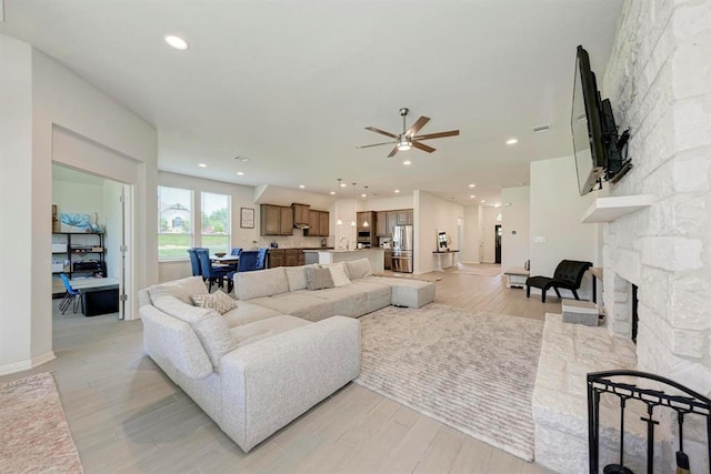 living room featuring a fireplace and light hardwood / wood-style floors