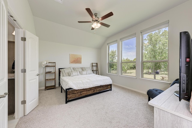 bedroom with ceiling fan, vaulted ceiling, and light carpet