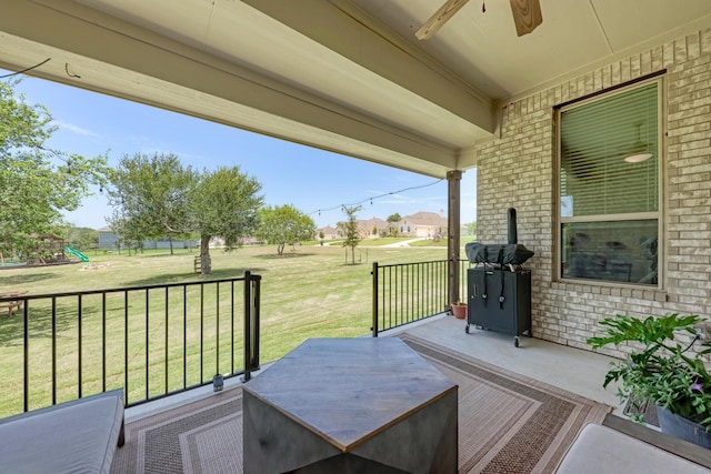 view of patio / terrace with ceiling fan and a playground