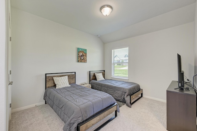 carpeted bedroom with lofted ceiling