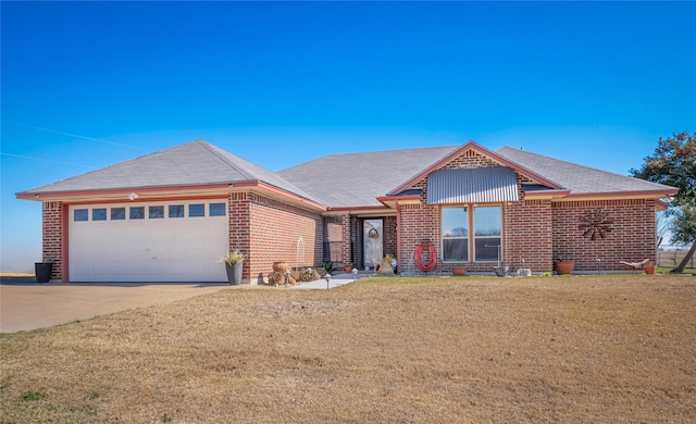 view of front of house featuring a garage and a front lawn