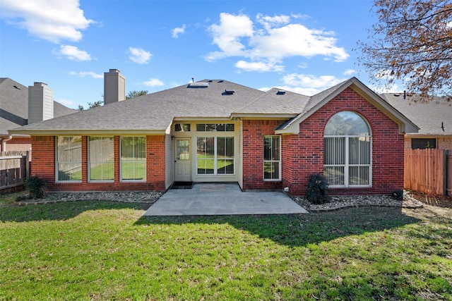 back of house featuring a yard and a patio