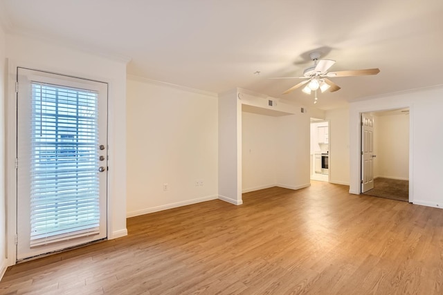 empty room featuring ceiling fan, ornamental molding, light hardwood / wood-style floors, and a healthy amount of sunlight