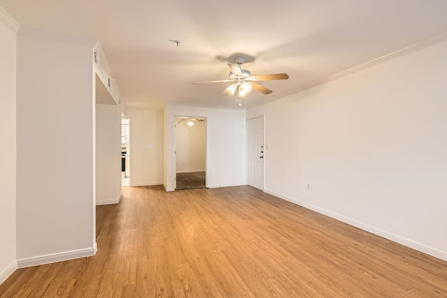 spare room with ornamental molding, ceiling fan, and light hardwood / wood-style floors