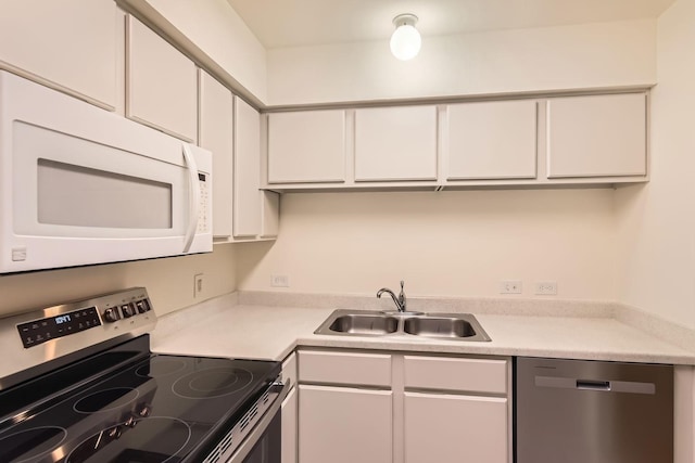 kitchen with white cabinetry, appliances with stainless steel finishes, and sink