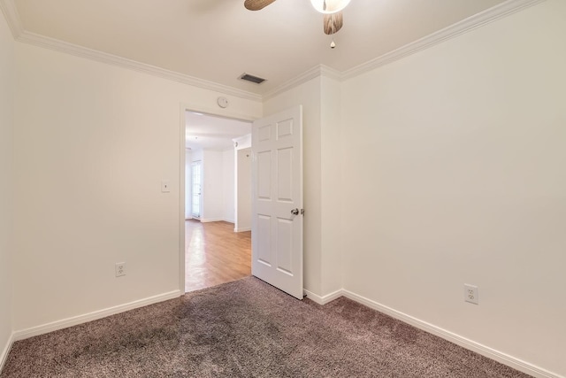 carpeted empty room featuring crown molding and ceiling fan