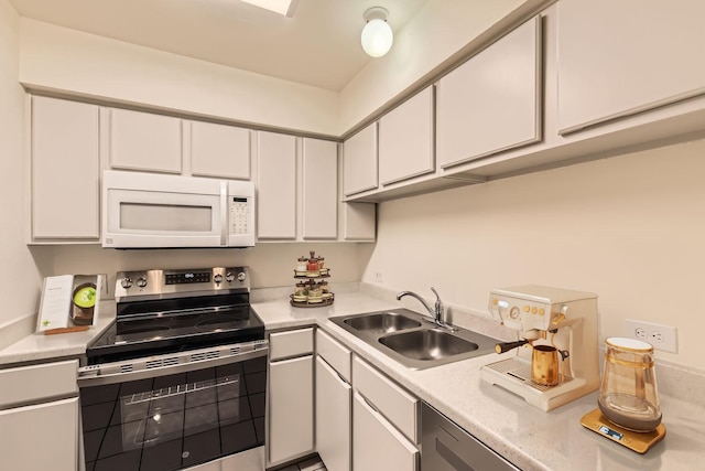 kitchen featuring white cabinetry, stainless steel range with electric stovetop, and sink