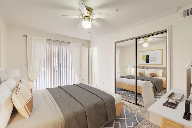 carpeted bedroom with crown molding, ceiling fan, and a closet