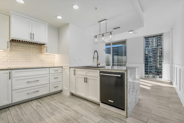 kitchen featuring white cabinetry, sink, and dishwasher