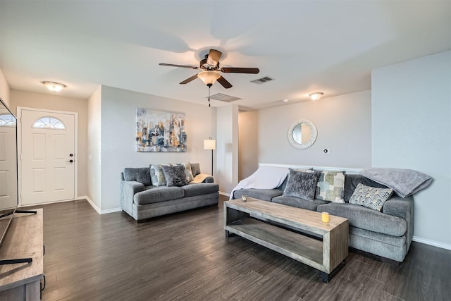 living room featuring ceiling fan and dark hardwood / wood-style flooring