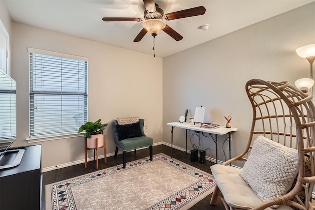 sitting room with hardwood / wood-style flooring and ceiling fan