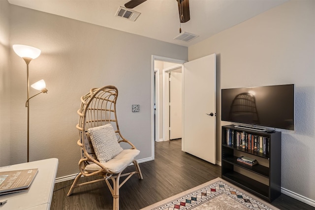 sitting room with dark hardwood / wood-style flooring and ceiling fan