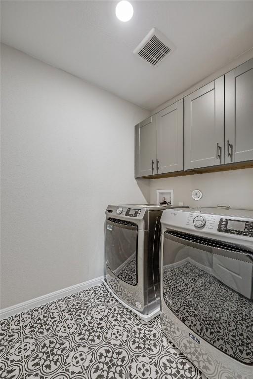 7001 Lewiston Way, Austin, TX 78724 - washroom with cabinet space and washing machine and clothes dryer