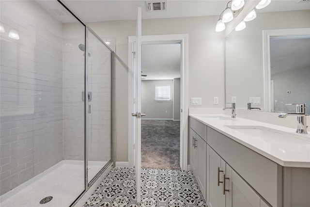 bathroom with tile patterned flooring, an enclosed shower, and vanity