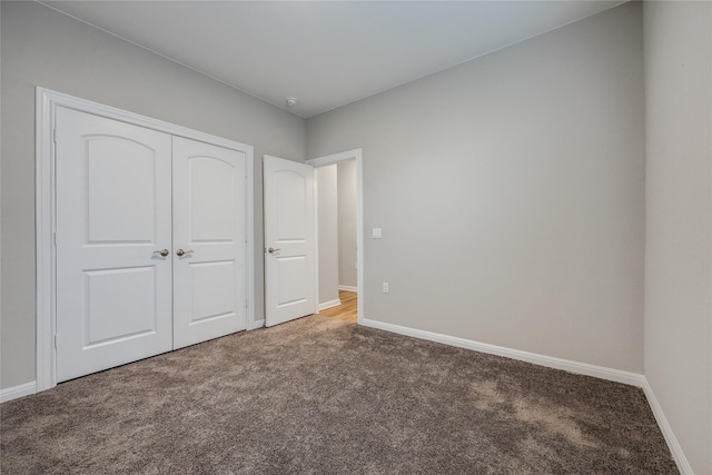 unfurnished bedroom featuring a closet and carpet