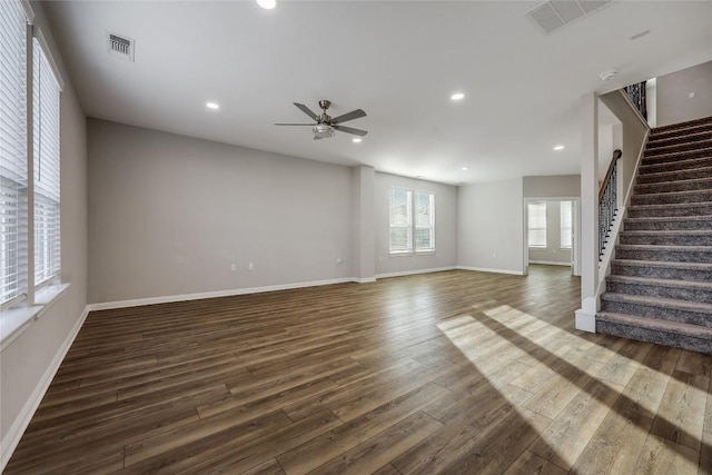 7001 Lewiston Way, Austin, TX 78724 - unfurnished living room with dark wood-style flooring, a ceiling fan, stairway, and recessed lighting