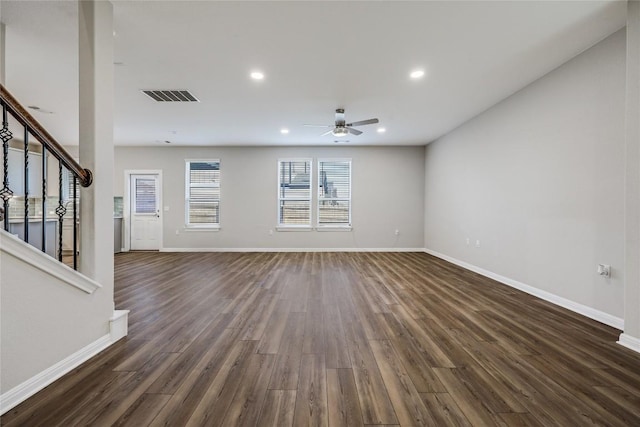7001 Lewiston Way, Austin, TX 78724 - unfurnished living room with dark wood-style floors, a ceiling fan, stairs, and recessed lighting
