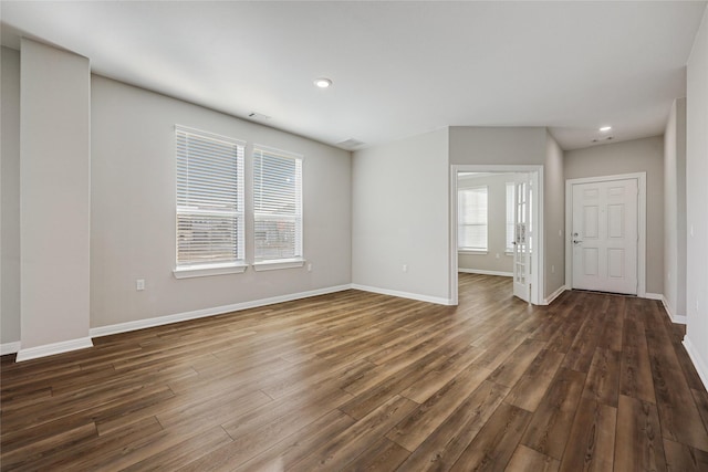 unfurnished living room featuring dark wood-type flooring