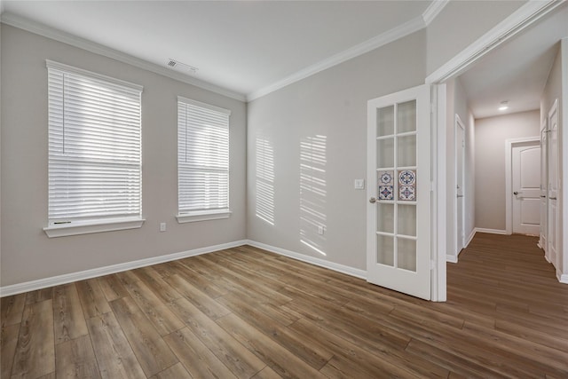 unfurnished room featuring hardwood / wood-style floors and crown molding