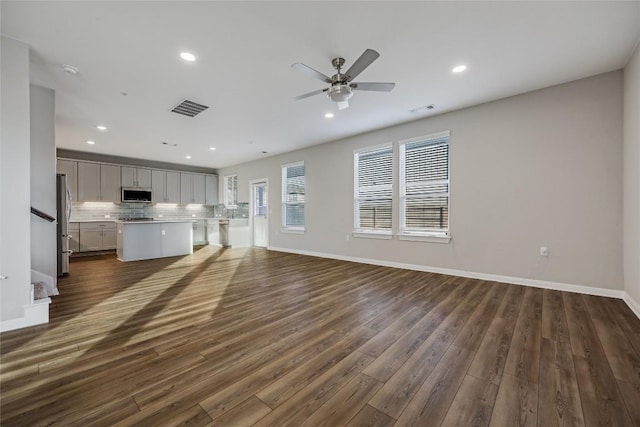 7001 Lewiston Way, Austin, TX 78724 - unfurnished living room featuring dark wood finished floors, ceiling fan, and recessed lighting