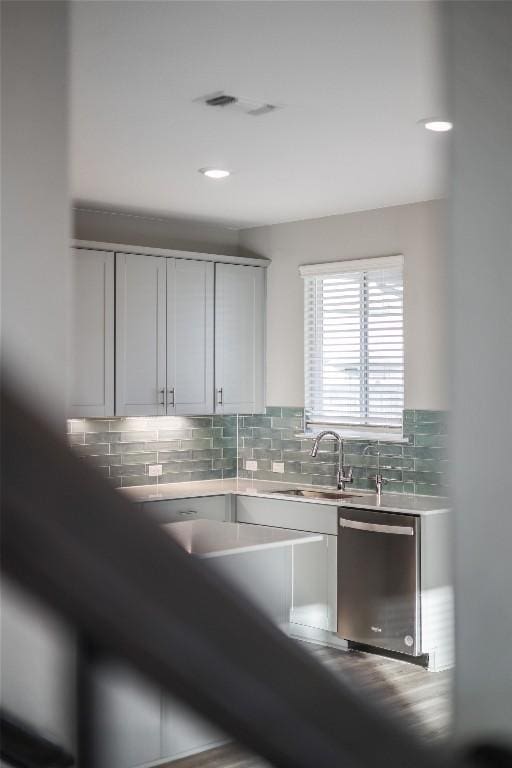 7001 Lewiston Way, Austin, TX 78724 - kitchen featuring stainless steel dishwasher, backsplash, white cabinets, and light countertops