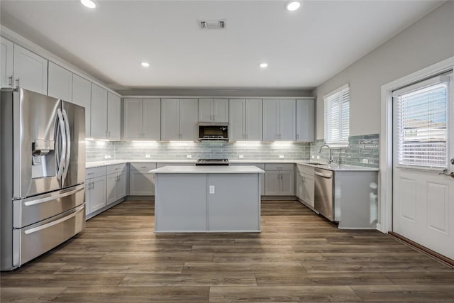 7001 Lewiston Way, Austin, TX 78724 - kitchen featuring stainless steel appliances, a kitchen island, light countertops, tasteful backsplash, and recessed lighting