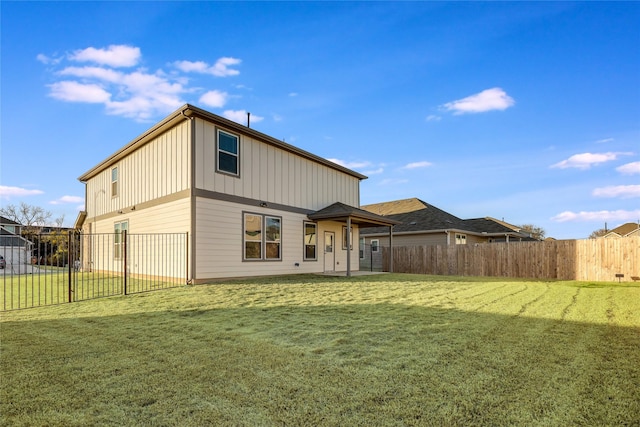 rear view of house with a yard