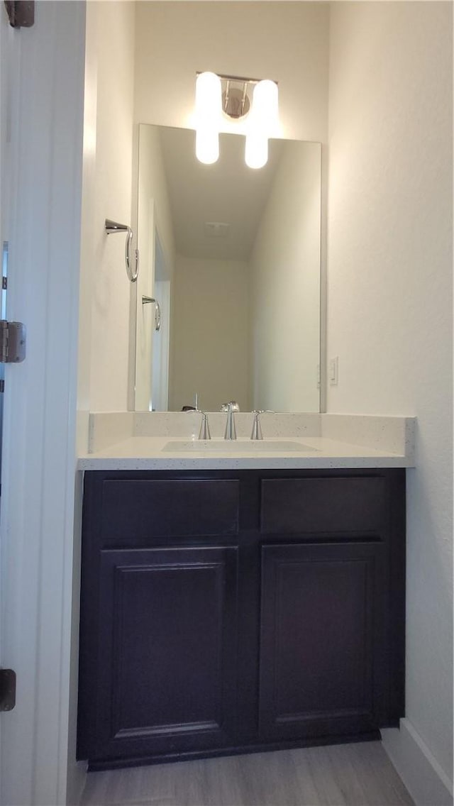 bathroom featuring vanity and wood-type flooring