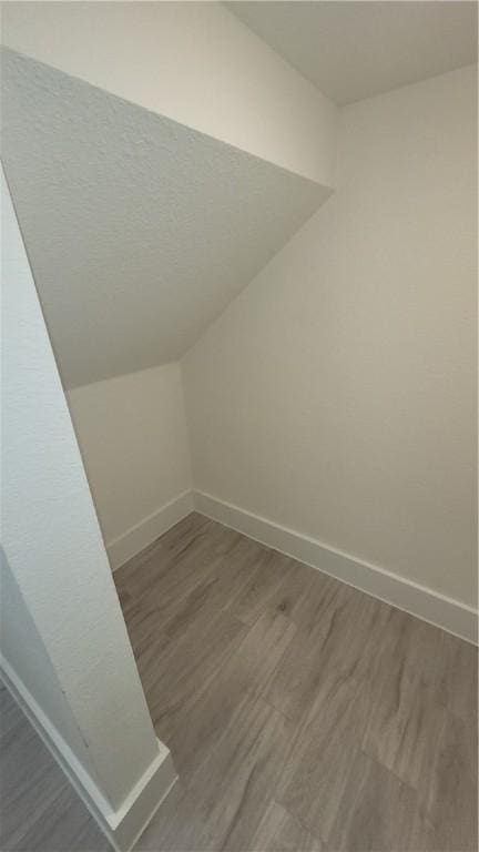 12320 Maypole Bnd, Austin, TX 78717 - additional living space featuring baseboards, wood finished floors, and vaulted ceiling