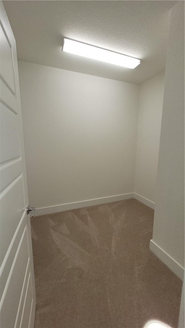 empty room featuring dark colored carpet and a textured ceiling