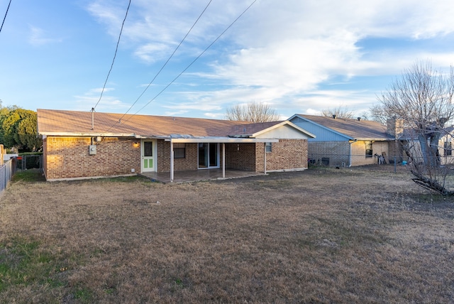 back of property featuring a yard and a patio area