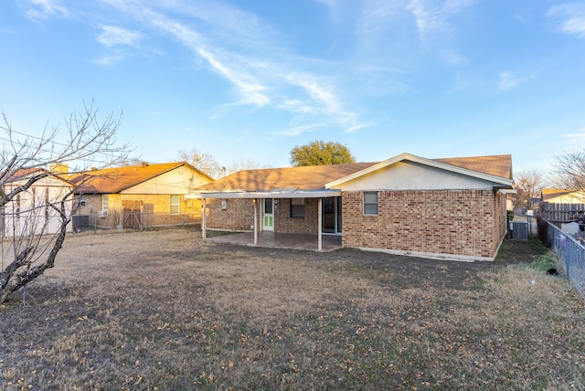 back of house featuring central AC unit and a patio