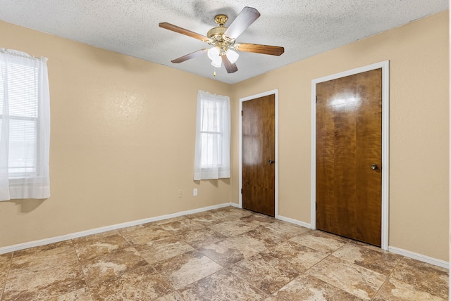 unfurnished bedroom featuring ceiling fan and a textured ceiling