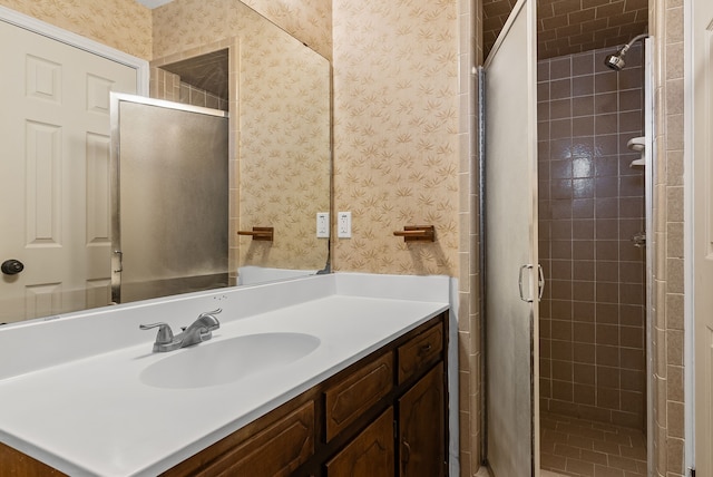 bathroom with walk in shower and vanity